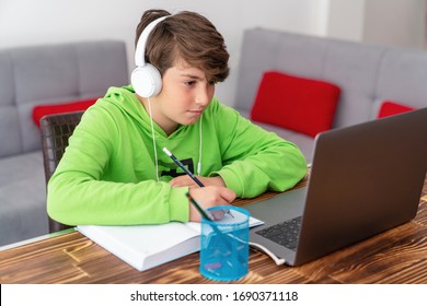 Young Boy Is Studying In Front Of The Laptop. E Learning, Study At Home Online.