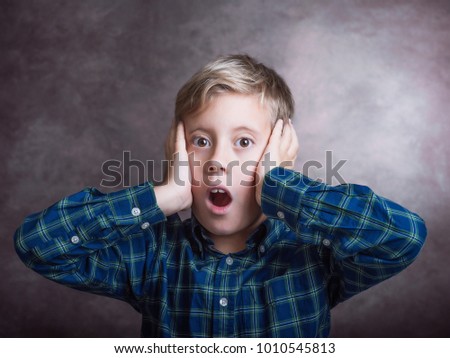 Young boy surprised.