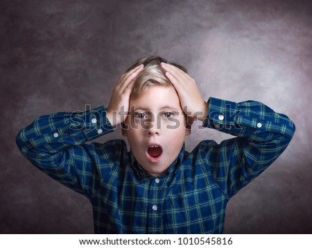 Young boy surprised.