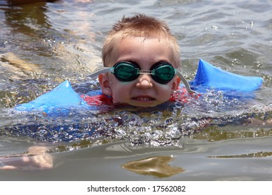 Young Boy Swimming In The Lake