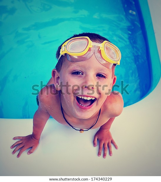 a young boy swimming in a small pool\
done with a vintage retro instagram\
filter