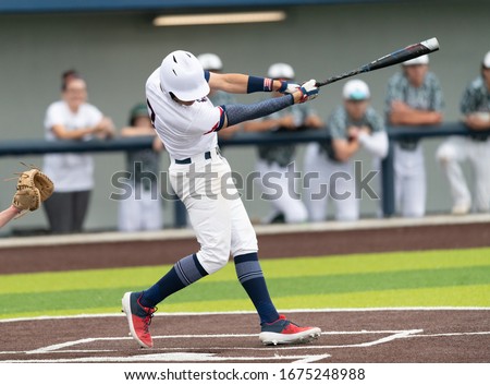 Young boy swinging the bat for a hit in baseball game