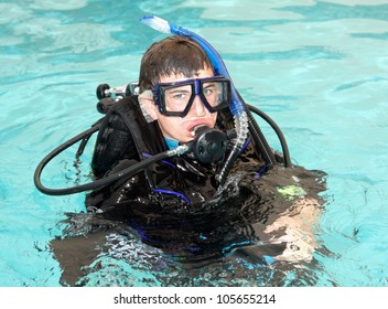 Young Boy Taking Scuba Diving Lessons In Pool.