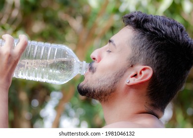 young boy taking water straight from the bottle - Powered by Shutterstock