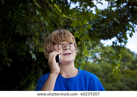 A young boy talking on a cell phone.