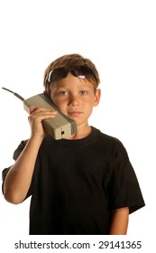 A Young Boy Talks On A Old 1980s Era Brick Cell Phone Isolated On White