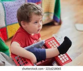 Young Boy Is Tangled Up Inside His Toy