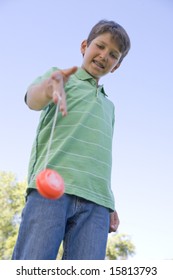 Young Boy Using Yo Yo Outdoors Smiling