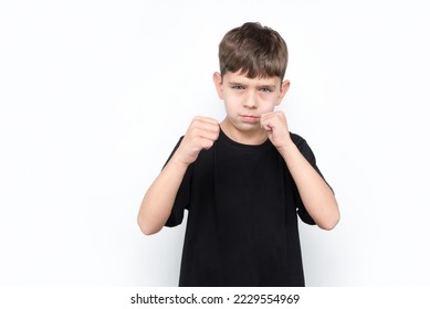 A young boy is very offended, he is about to cry, he raised his hands to protect himself, the concept of self-defense, raising self-esteem. The boy is insulted by older boys in the yard