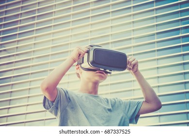 Young boy with virtual reality goggles in the city - Powered by Shutterstock