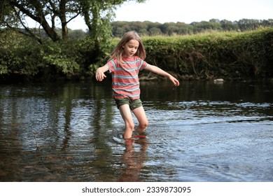 Young boy wading in a stream 