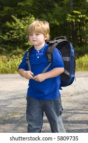 Young Boy Waiting For The School Bus On First Day Of School