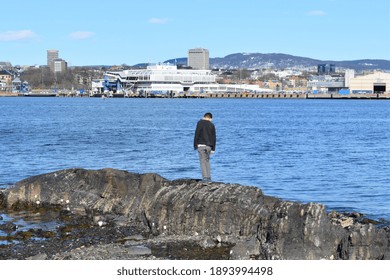 A Young Boy Walking On The Rocks. Outdoor View Of Central Oslo From The Bank Of Bygdøy Peninsula In Oslo, Norway. 