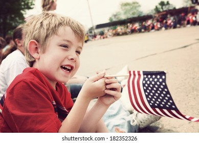 Young boy watching Holiday parade - Shutterstock ID 182352326