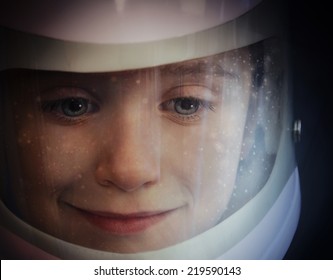 A young boy is wearing an astronaut helmet and looking into space with stars for an education or imagination concept.