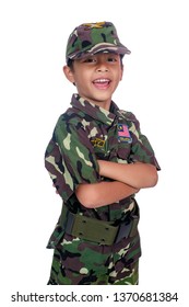 A Young Boy Wearing A Malaysian Army Costume And A Toy Gun Isolated On White Background