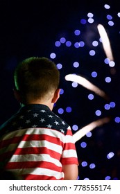 Young Boy Wearing Stars And Stripes Watching Fireworks On The 4th Of July.