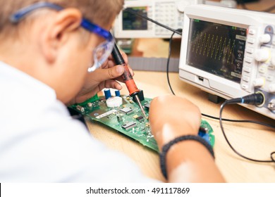 Young boy working on an electronics project