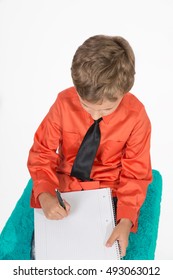young boy write something