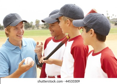 Young Boys In Baseball Team With Coach