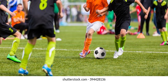 Young Boys Children In Uniforms Playing Youth Soccer Football Game Tournament. Horizontal Sport Background.