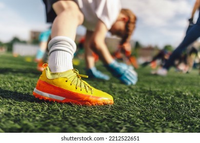 Young Boys At Football Goalkeepers Training Session. Kids Practicing Soccer Goalie Skills With Coach. Junior Level Soccer Goalie Stretching At Grass Pitch