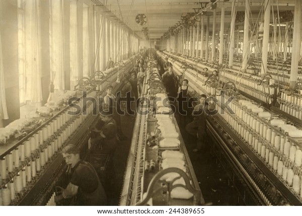 Young boys and girls working in the spinning room of the Cornell Mill in Fall River, Massachusetts. January 1912 photo by Lewis Hine.