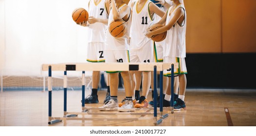 Young boys on basketball training. Group of school boys practicing basketball. Kids play sports during basketball training drills on a wooden court. Youth players ready to play training duel - Powered by Shutterstock