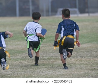 Young Boys Playing In A Game Of Flag Football