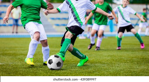 Young Boys Playing Soccer Game On The Professional Football Pitch. Football Soccer Tournament For Youth Teams.