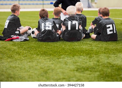 Young Boys In Soccer Football Team With Coach. Motivation Talk Before Soccer Match. Little League Soccer Boys Team.