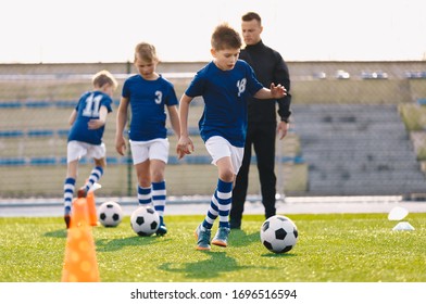 Young Boys In Sports Soccer Club On Training Unit. Kids Improve Soccer Skills On Natural Turf Grass Pitch. Football Practice Session For Children Youth Team. Junior Level Professional Soccer School