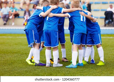 Young boys sports team on stadium. Football players in sportswear motivating before the match. Youth soccer tournament game for kids - Powered by Shutterstock