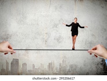 Young brave ricky businesswoman balancing on rope