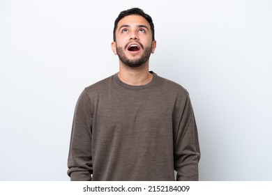 Young Brazilian man isolated on white background looking up and with surprised expression - Shutterstock ID 2152184009