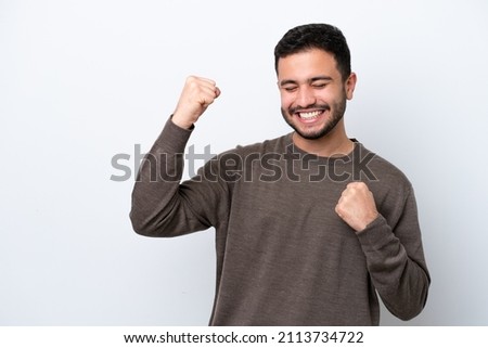 Young Brazilian man isolated on white background celebrating a victory