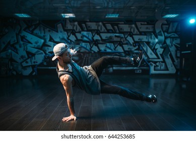 Young breakdance performer dancing in studio