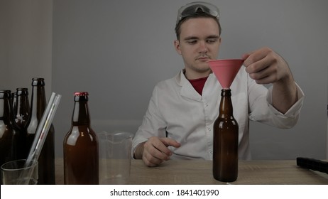 a young brewer prepares products and checks the quality of the equipment and the quality of honey beer brewed at home - Powered by Shutterstock