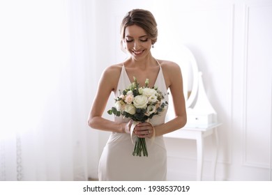 Young bride with beautiful wedding bouquet in room - Powered by Shutterstock