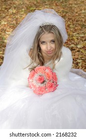 The Young bride before rite. White gown bridal veil