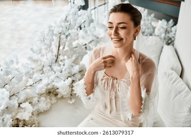 Young bride dressed elegantly, surrounded by flowers, showcasing a joyful smile on her special day.