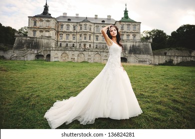 young bride posing against castle in west Ukraine