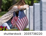 A young bride shows her grief at the burial site of a family member at a military cemetery