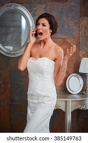 Young bride talking on mobilephone, gesturing and shouting upset.