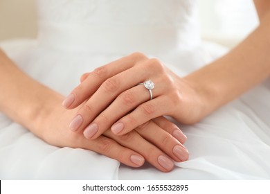 Young bride wearing beautiful engagement ring, closeup