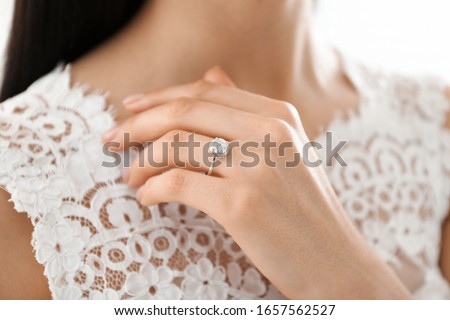 Young bride wearing beautiful engagement ring, closeup