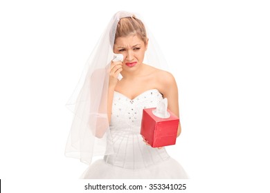 Young Bride In A Wedding Dress Crying And Wiping Her Tears Isolated On White Background