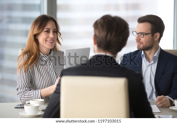 Young broker businesswoman talking to business partners. Woman ...