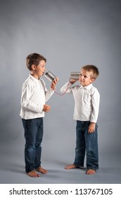 Young Brothers Talking With Tin Can Telephone.