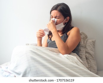 Young Brown Hair Hispanic Female Is Sick, She Blows Her Nose And Rests In Bed In Quarantine In Quarantine